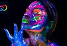 Nye Adobe Creative Cloud-abonnenter bør tjekke disse fremragende gratis ressourcer Kvinde med neonlys malet på ansigtet og hænderne på en sort baggrund, med Adobe Creative Cloud logo i øverste venstre hjørne.